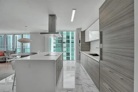 a kitchen with stainless steel appliances kitchen island granite countertop a sink and cabinets