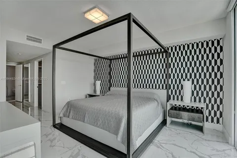 a bedroom with a bed and a chair