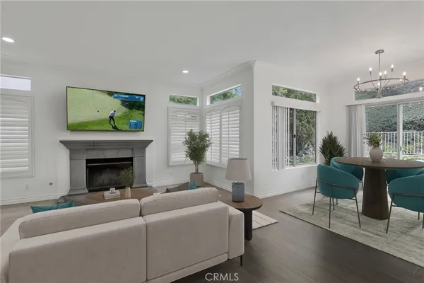 a living room with furniture a fireplace and a large window
