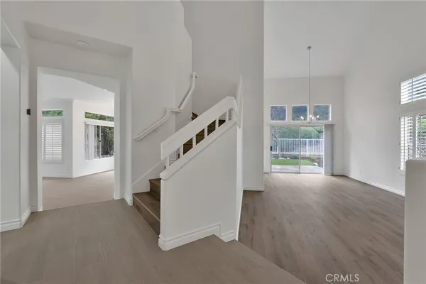a view of entryway and hall with wooden floor