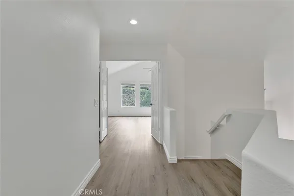 a spacious bedroom with a bed couch and window