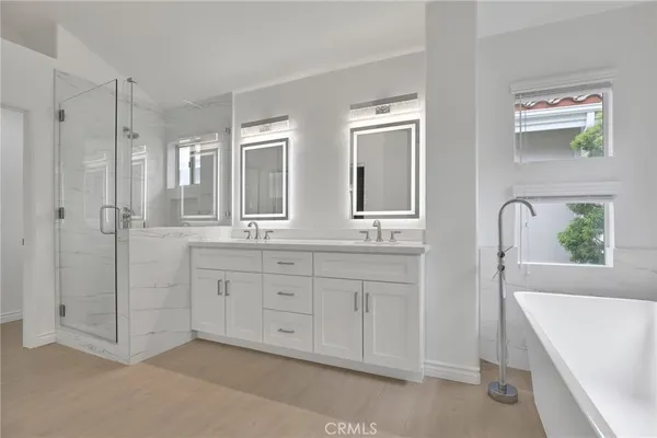 a bathroom with sink mirror and window