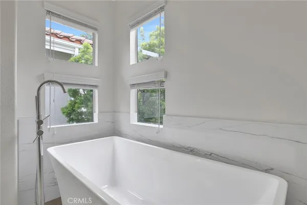 a bathroom with double vanity sink a two mirror a window with vanity