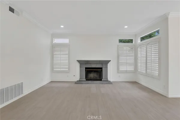 a view of empty room with fireplace