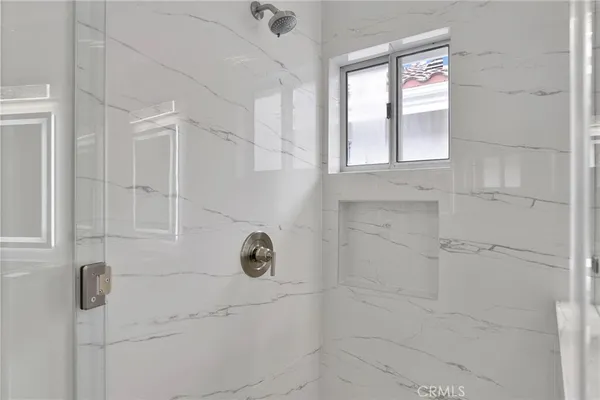 an empty room with wooden floor and a window