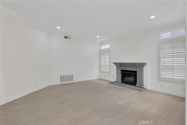 a view of empty room with a fireplace