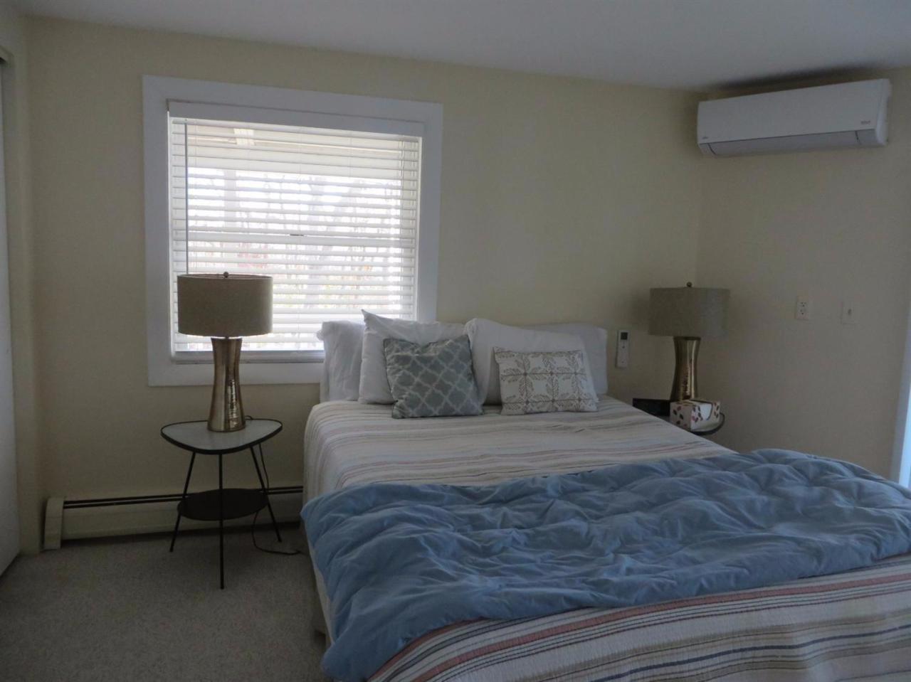 160 Huckins Neck Road Centerville, MA 02601 - Photo 15 of 25 a bedroom with a bed and a table