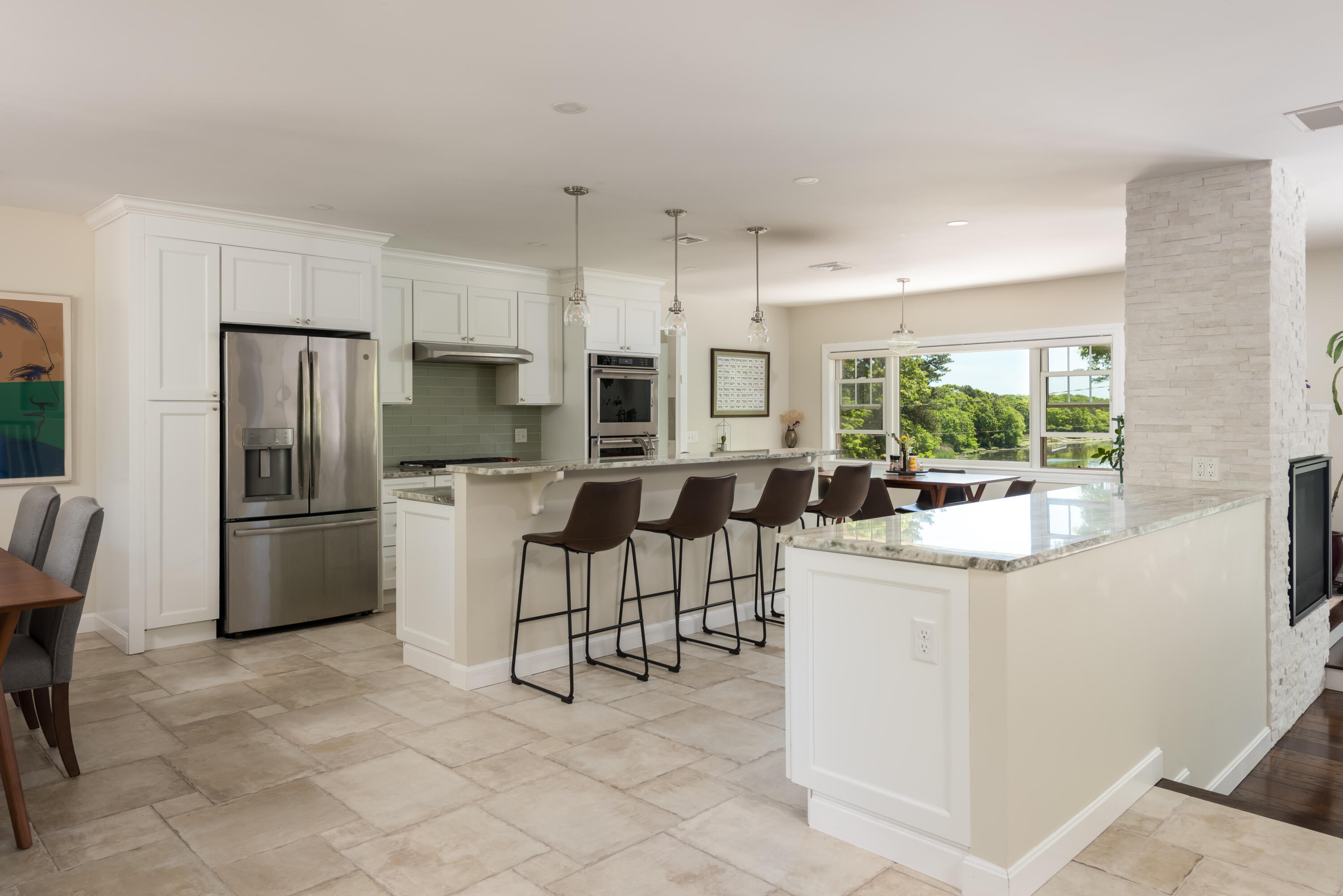180 Riverview Lane Centerville, MA 02632 - Photo 11 of 55 a kitchen with stainless steel appliances a refrigerator a stove a sink a dining table and chairs