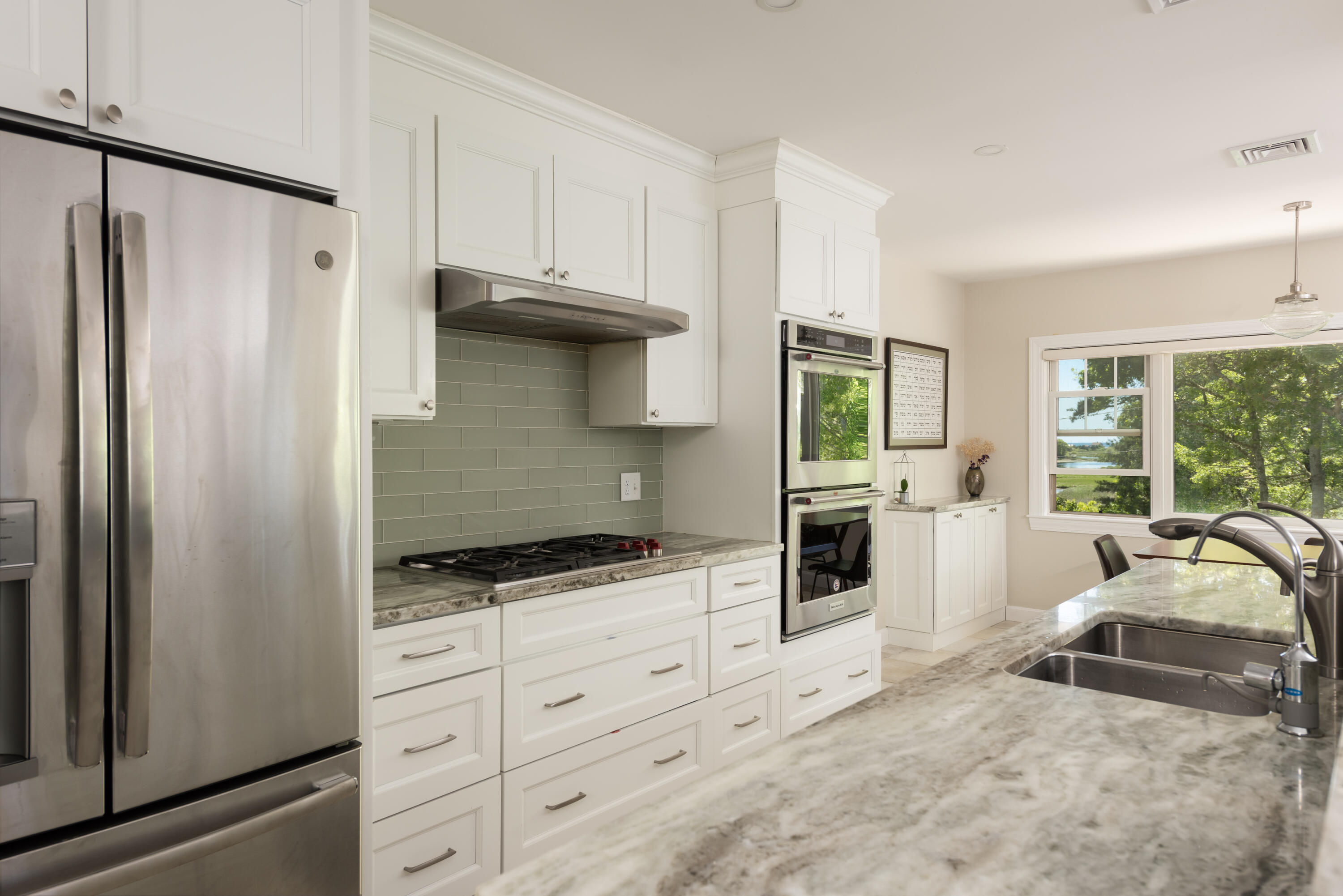 180 Riverview Lane Centerville, MA 02632 - Photo 13 of 55 a kitchen with granite countertop a stove a sink and a refrigerator