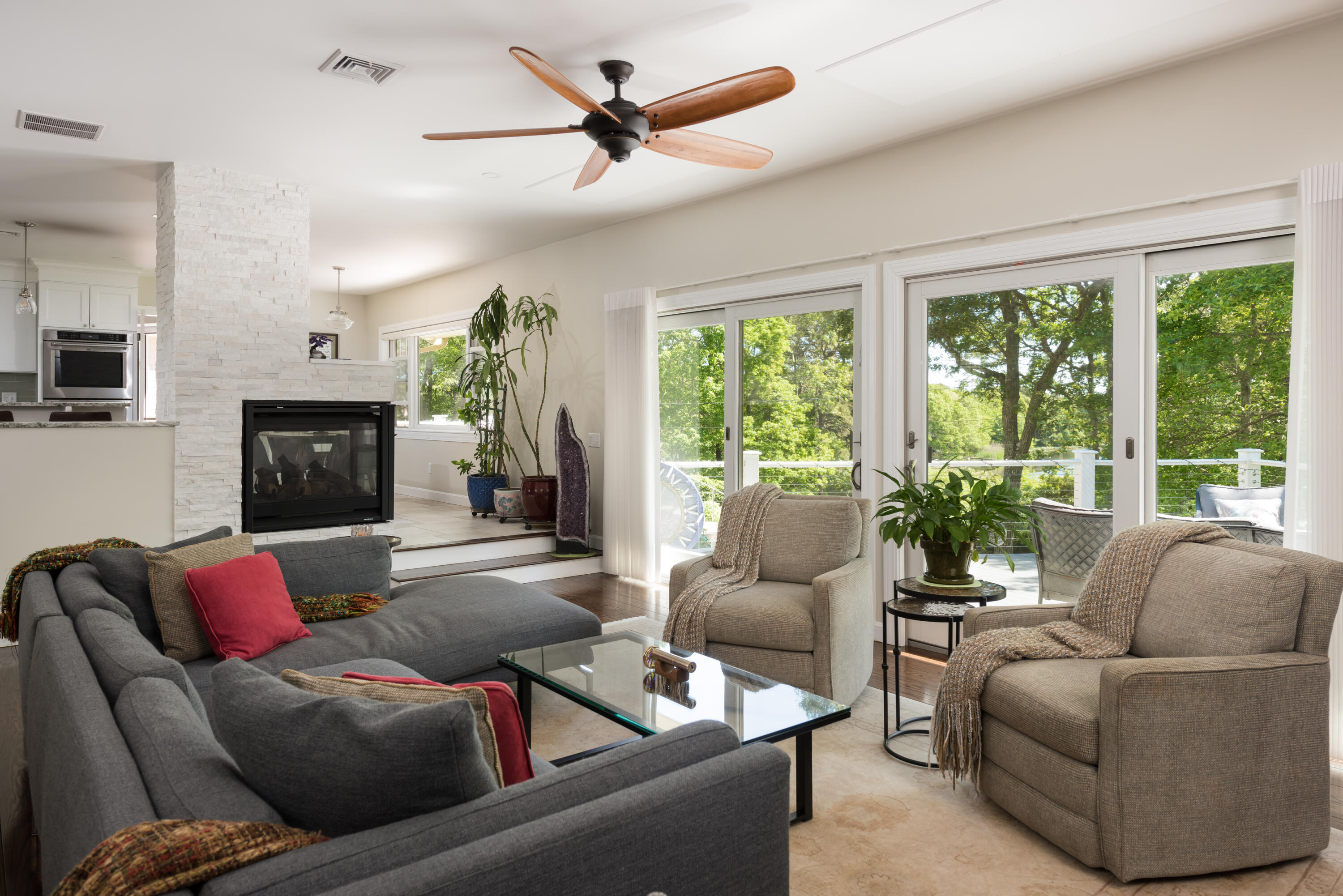 180 Riverview Lane Centerville, MA 02632 - Photo 20 of 55 a living room with furniture a flat screen tv and a large window