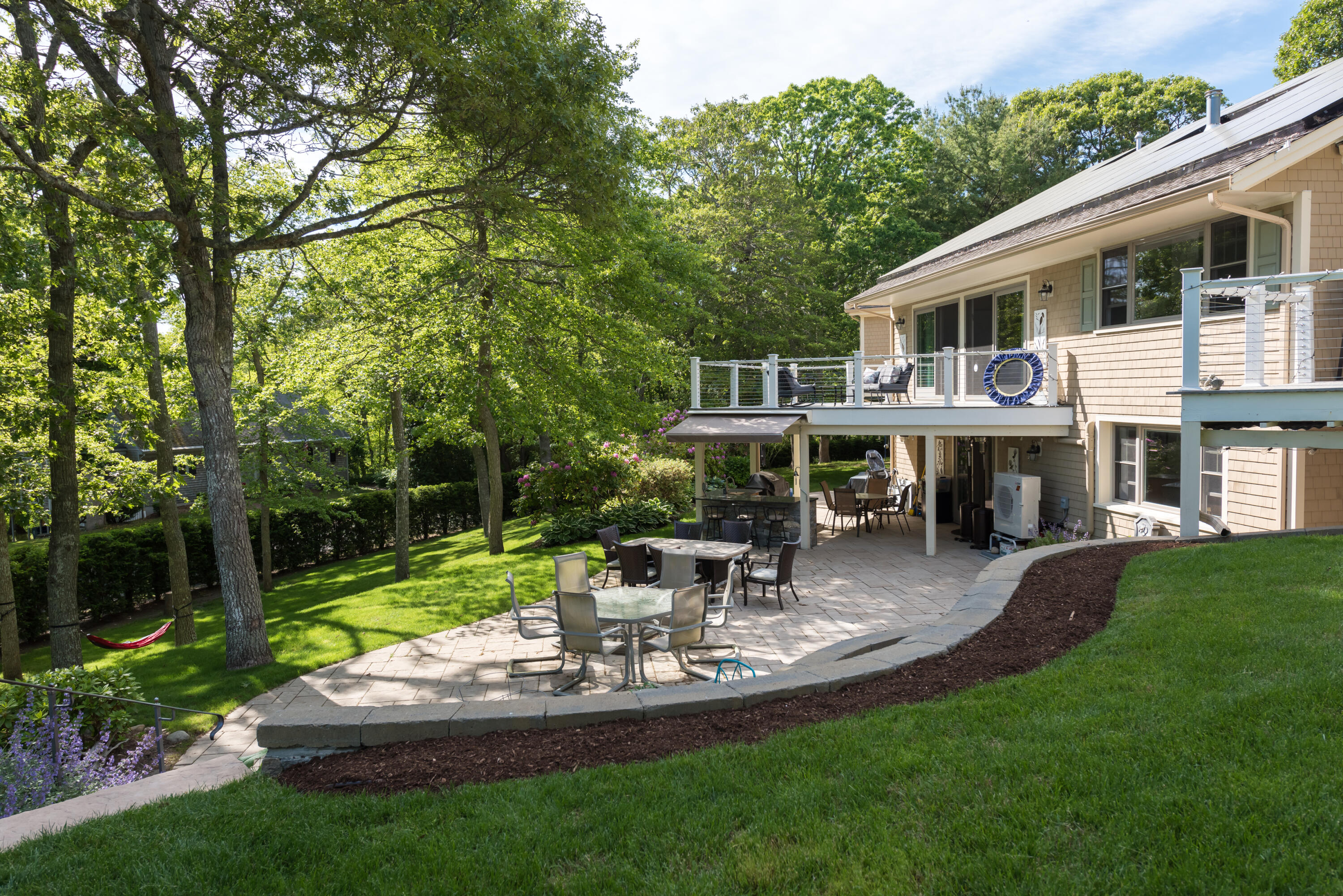 180 Riverview Lane Centerville, MA 02632 - Photo 42 of 55 a front view of a house with garden and sitting area