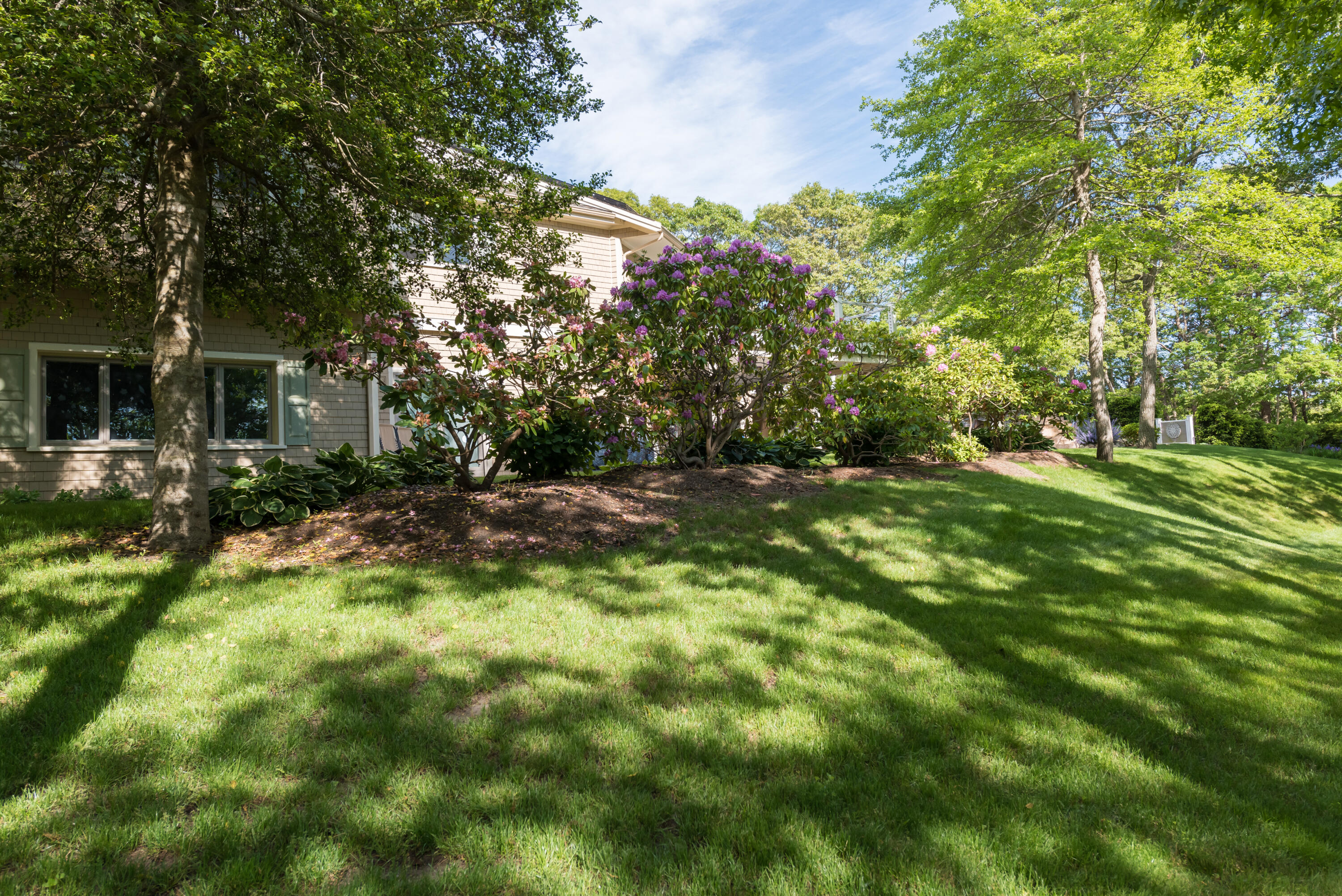 180 Riverview Lane Centerville, MA 02632 - Photo 46 of 55 a backyard of a house with table and chairs