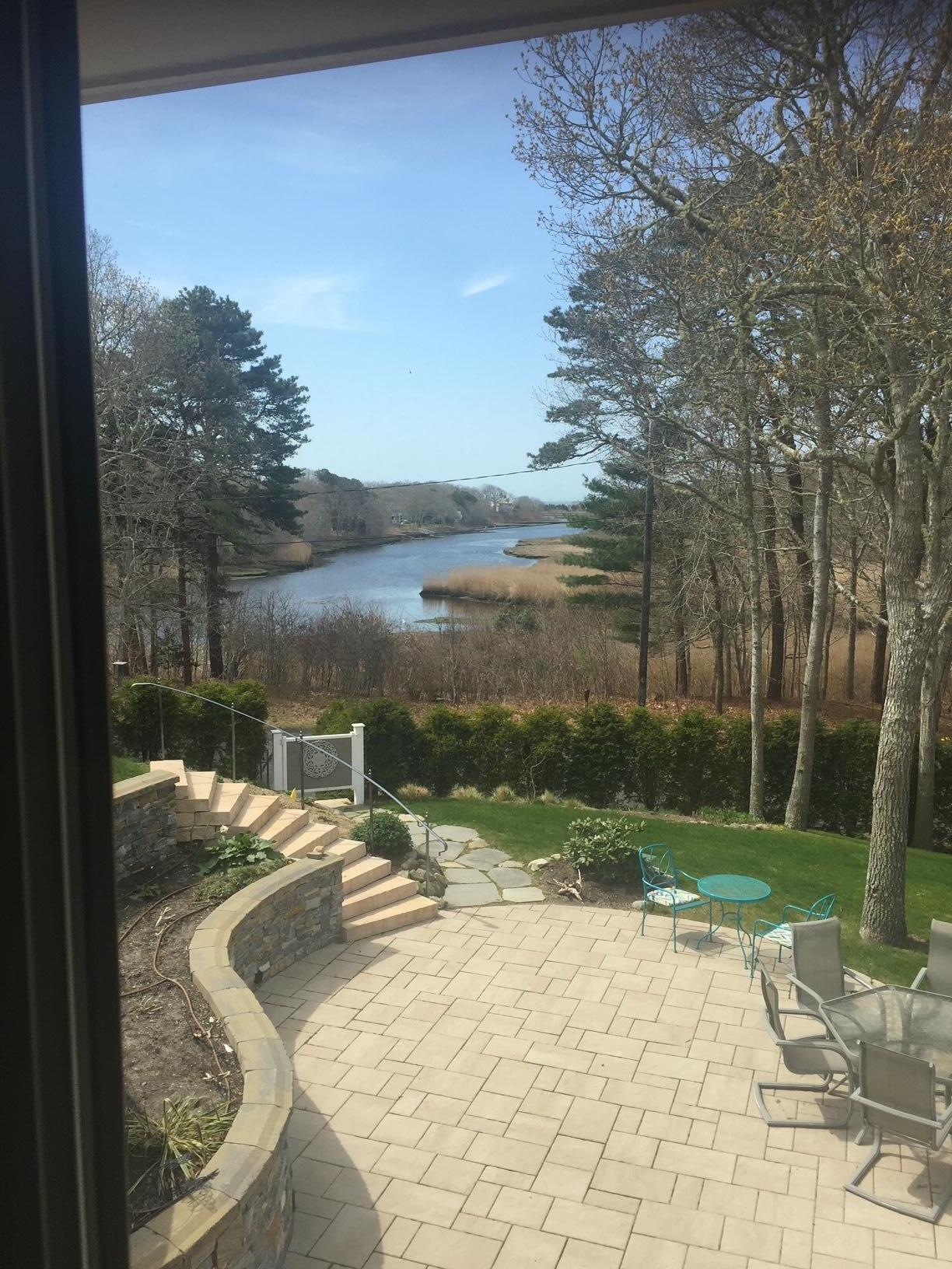 180 Riverview Lane Centerville, MA 02632 - Photo 5 of 55 a view of a lake with a yard