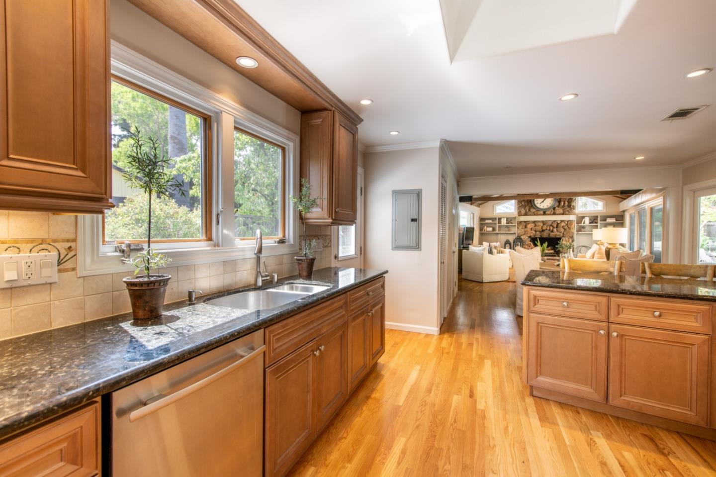 630 Covington Road Los Altos, CA 94024 - Photo 11 of 27 a large kitchen with granite countertop a large window a sink and stainless steel appliances