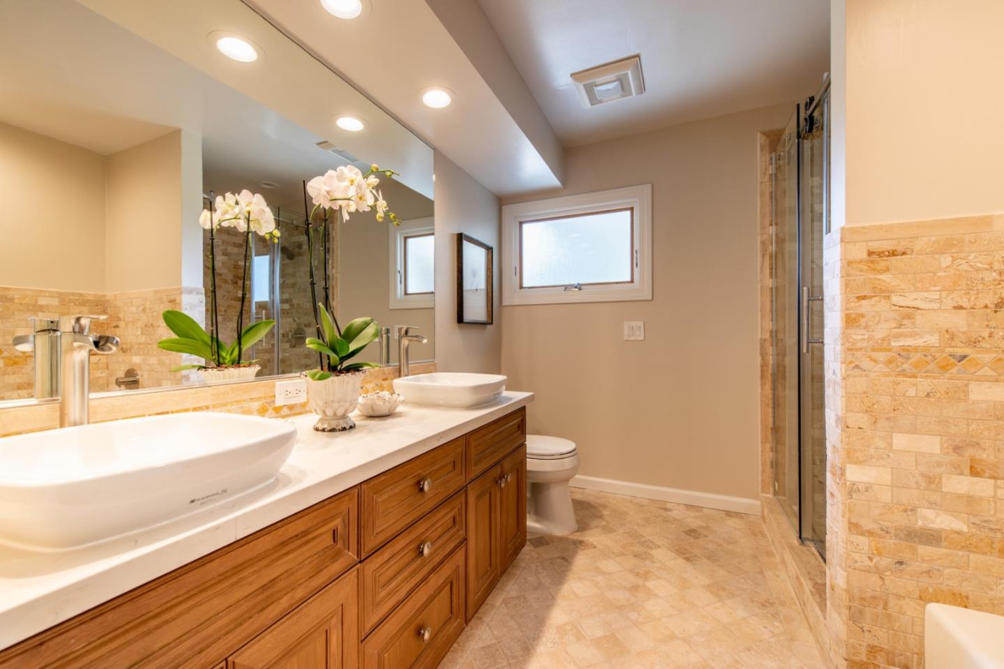 630 Covington Road Los Altos, CA 94024 - Photo 18 of 27 a spacious bathroom with a granite countertop sink and a mirror