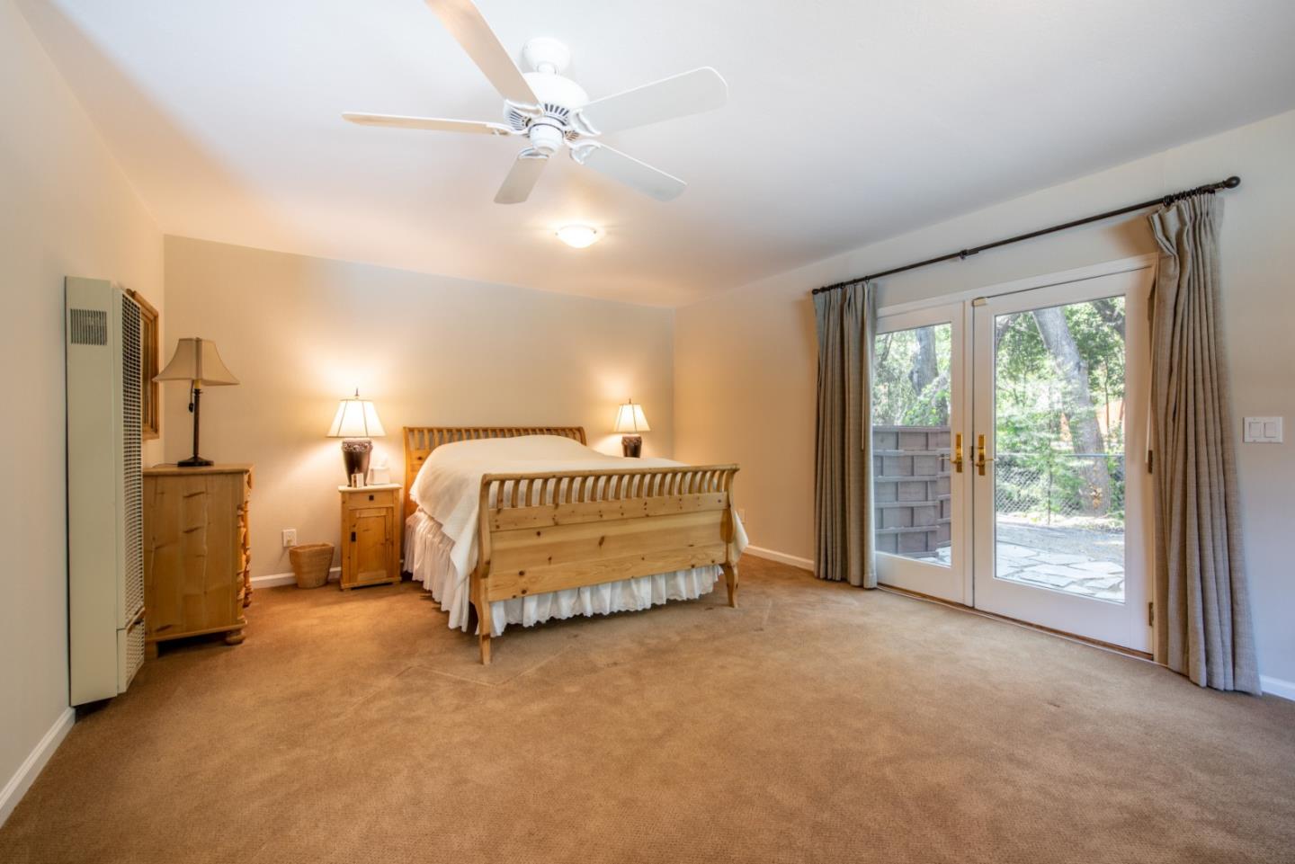 630 Covington Road Los Altos, CA 94024 - Photo 22 of 27 a spacious bedroom with a bed and a chandelier