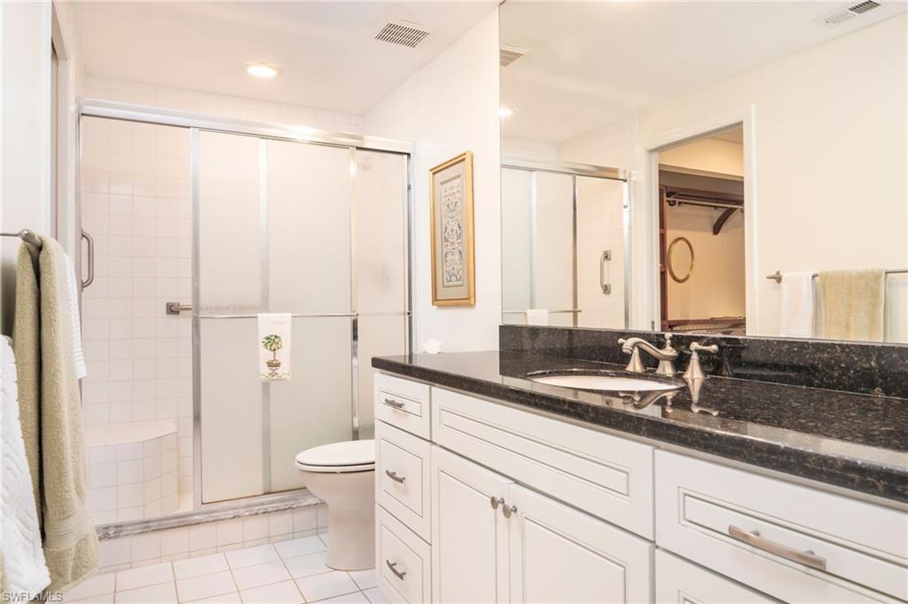 760 Willowbrook Drive, Unit 1202 Naples, FL 34108 - Photo 19 of 28 a bathroom with a double vanity sink toilet and shower