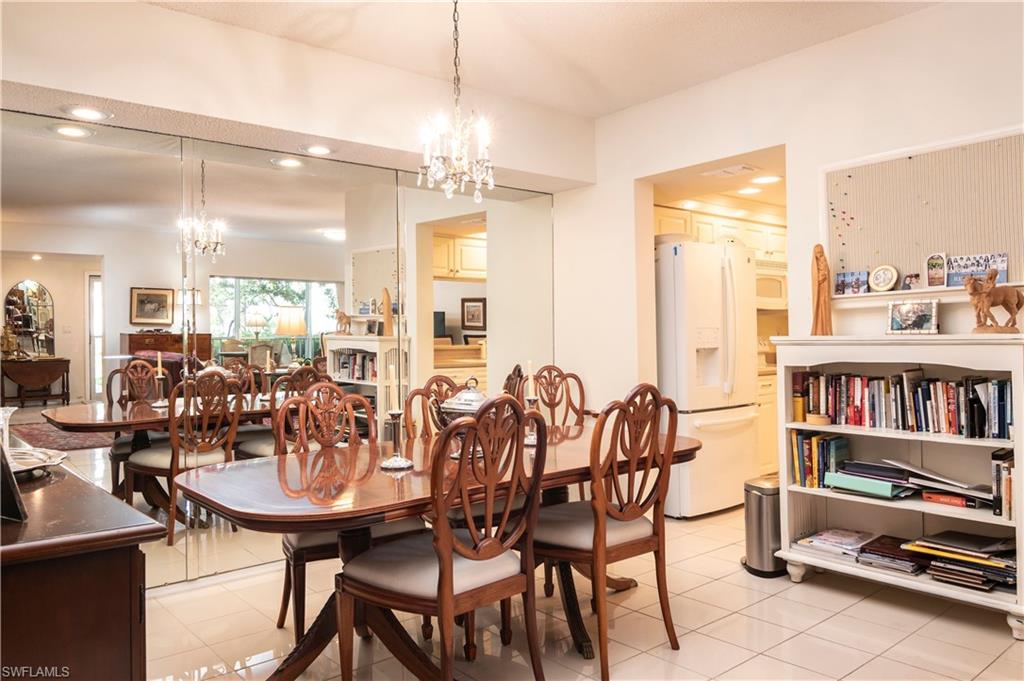 760 Willowbrook Drive, Unit 1202 Naples, FL 34108 - Photo 8 of 28 a view of a dining room with furniture window and wooden floor