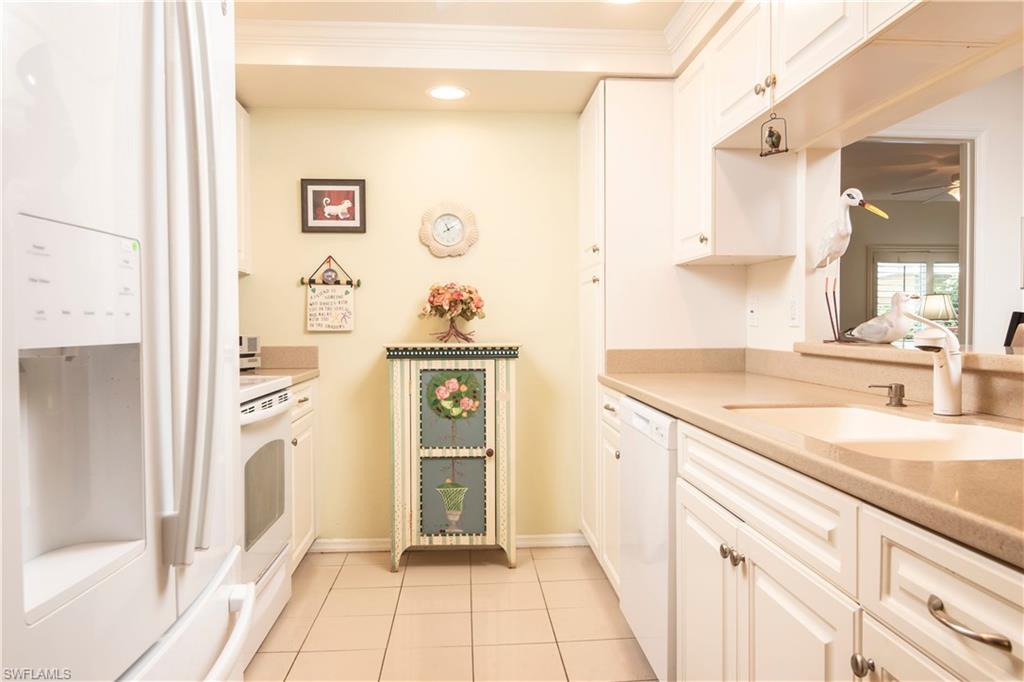 760 Willowbrook Drive, Unit 1202 Naples, FL 34108 - Photo 9 of 28 a bathroom with a granite countertop sink and a mirror