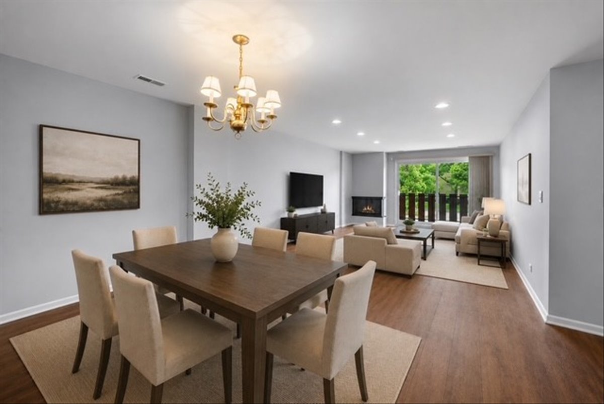 1795 Lake Cook Road, Unit 107 Highland Park, IL 60035 - Photo 5 of 26 a view of a dining room with furniture a chandelier and wooden floor