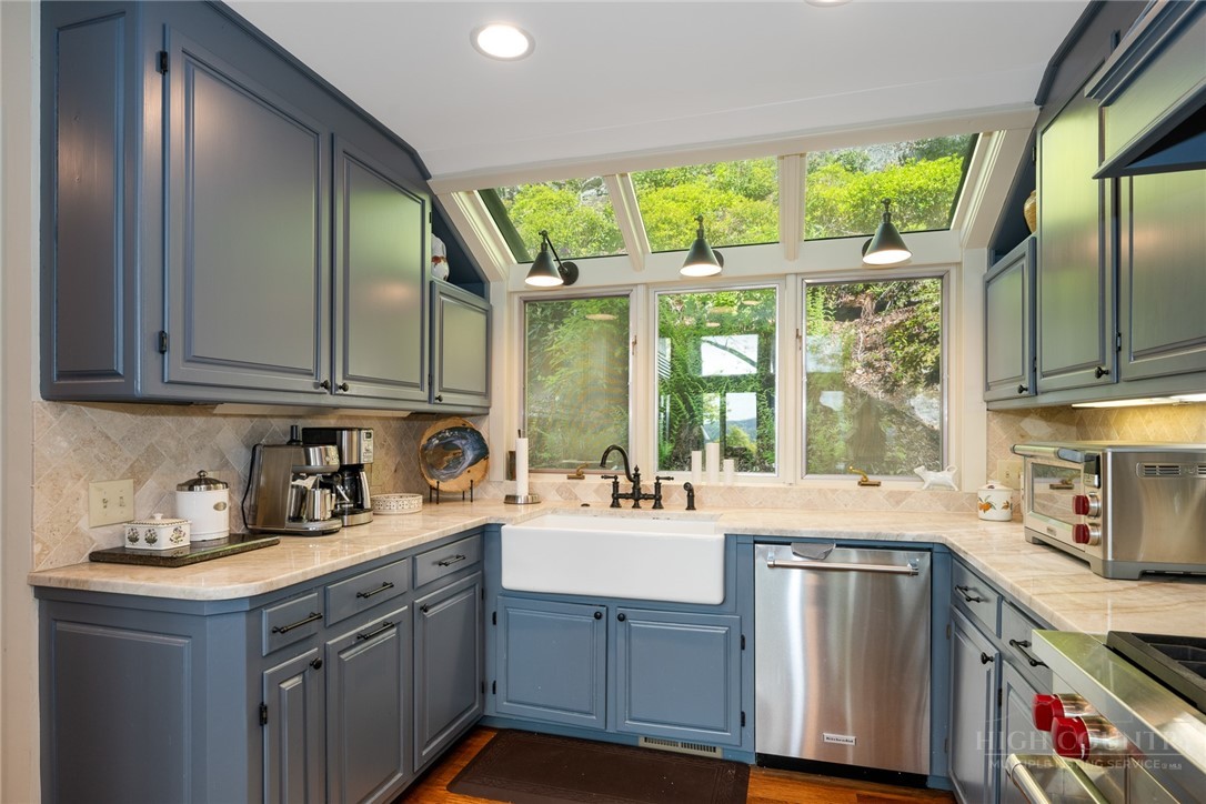 246 Mulberry Lane Boone, NC 28607 - Photo 26 of 49 a kitchen with stainless steel appliances granite countertop a sink a stove and a wooden cabinets