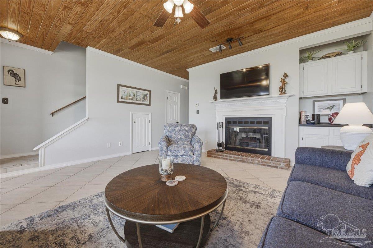 26063 Canal Road, Unit 3F Orange Beach, AL 36561 - Photo 19 of 72 a living room with furniture a fireplace and a flat screen tv