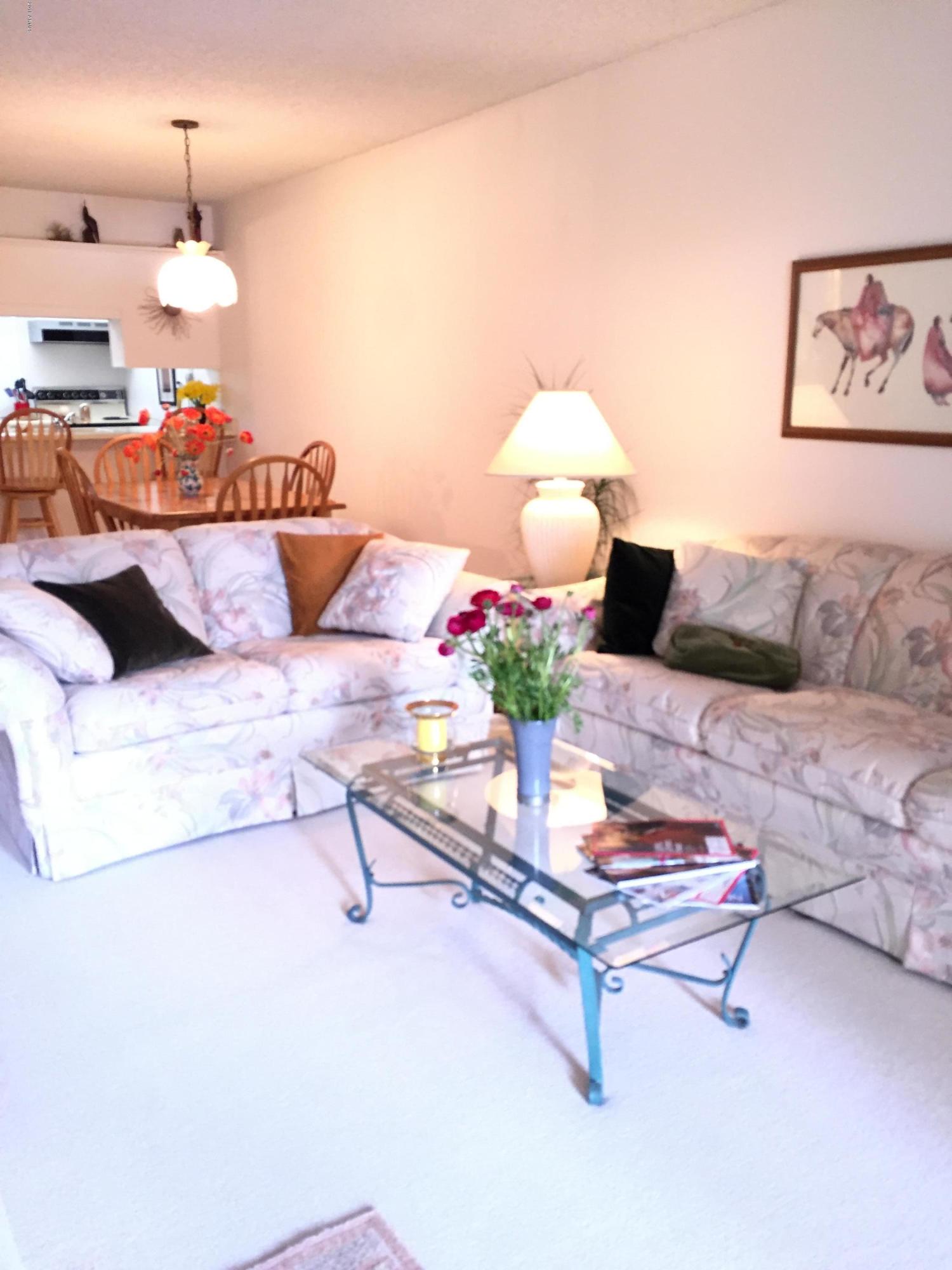 7436 East Chaparral Road, Unit 264B Scottsdale, AZ 85250 - Photo 14 of 27 a living room with furniture and a lamp