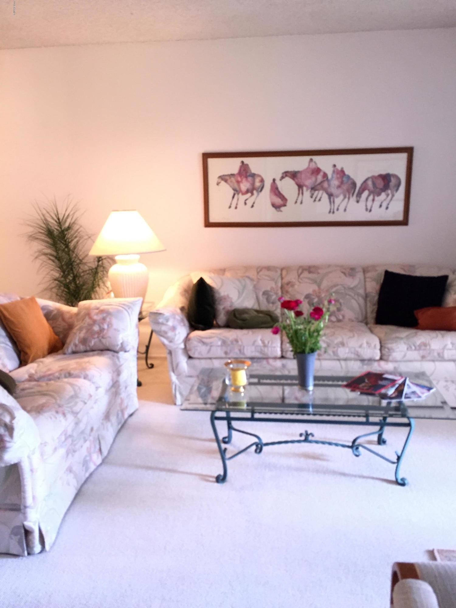7436 East Chaparral Road, Unit 264B Scottsdale, AZ 85250 - Photo 2 of 27 a living room with furniture and flowers