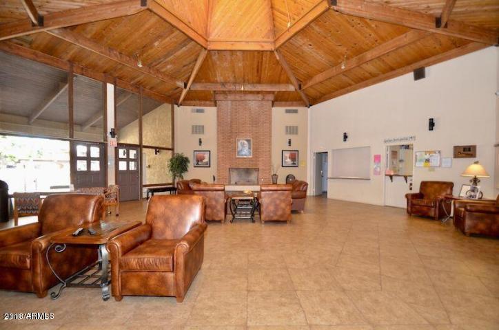 7436 East Chaparral Road, Unit 264B Scottsdale, AZ 85250 - Photo 24 of 27 a living room with furniture and a blue umbrella