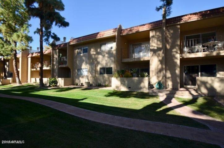 7436 East Chaparral Road, Unit 264B Scottsdale, AZ 85250 - Photo 25 of 27 a front view of a house with garden and sitting area