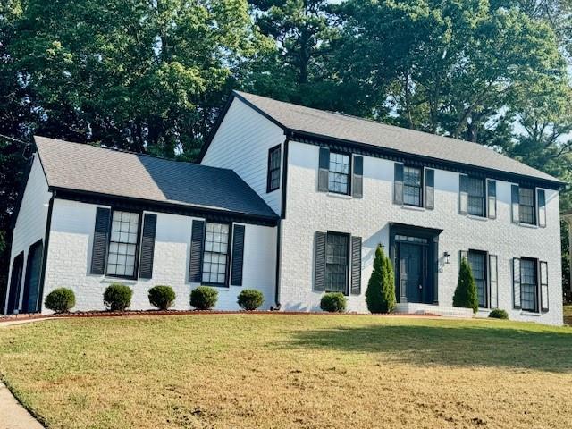 a front view of a house with garden