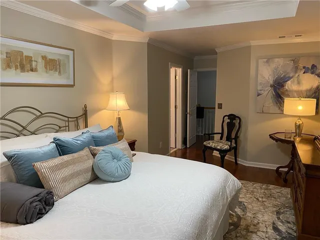 a bedroom with bed and a chair