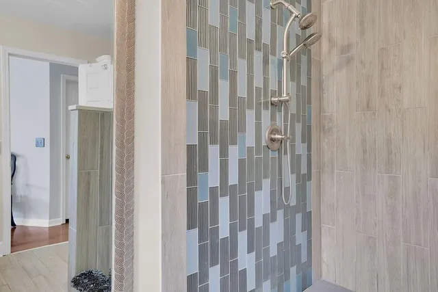 a bathroom with a shower and a glass door