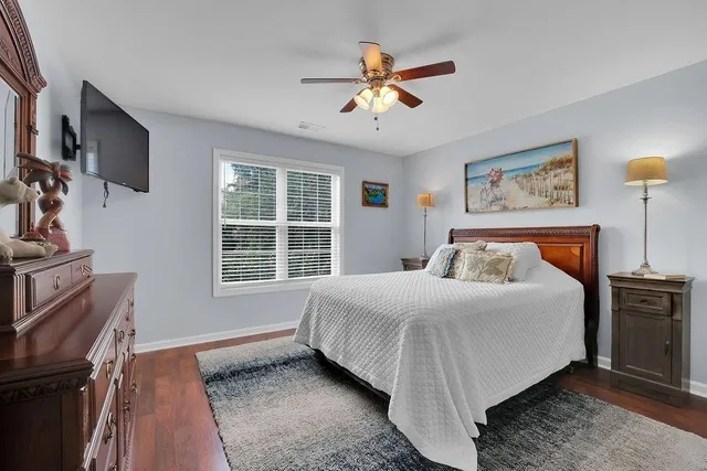 a bedroom with a large bed and a window