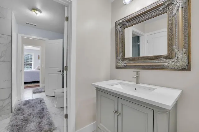 a bathroom with a sink and a mirror