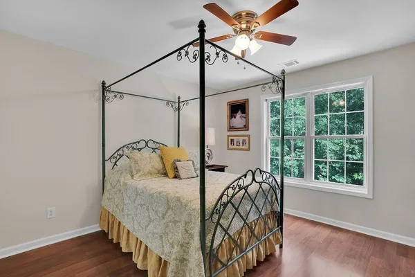 a bedroom with a bed next to a window