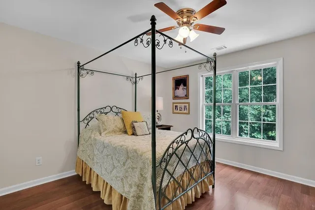 a bedroom with a bed next to a window