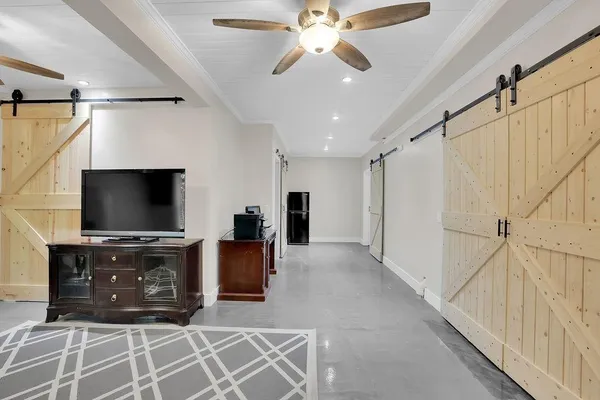 a living room with furniture and a flat screen tv