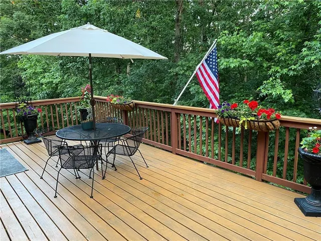 a view of balcony with wooden floor and outdoor seating