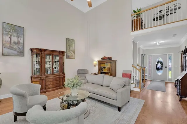 a living room with furniture and wooden floor