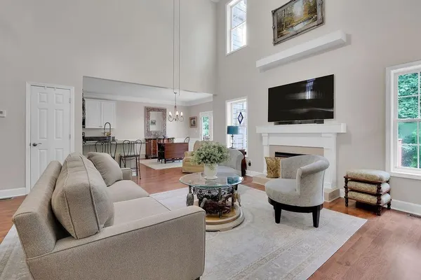 a living room with furniture a fireplace and a flat screen tv