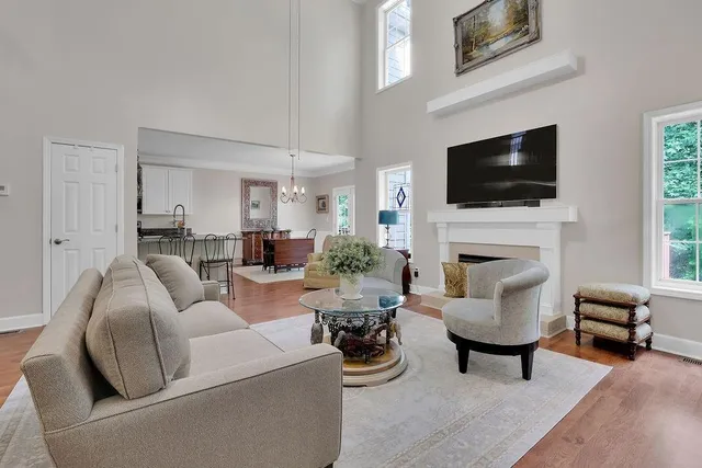 a living room with furniture a fireplace and a flat screen tv