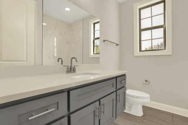 an empty room with closet and a ceiling fan