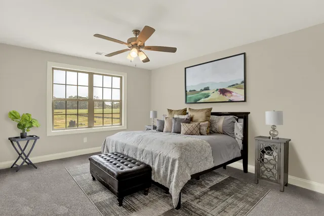 a living room with furniture a bookshelf and a large window