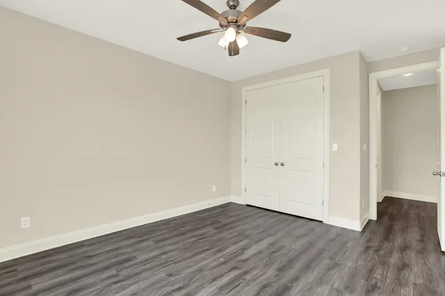 a bedroom with a bed a table and painting on the wall