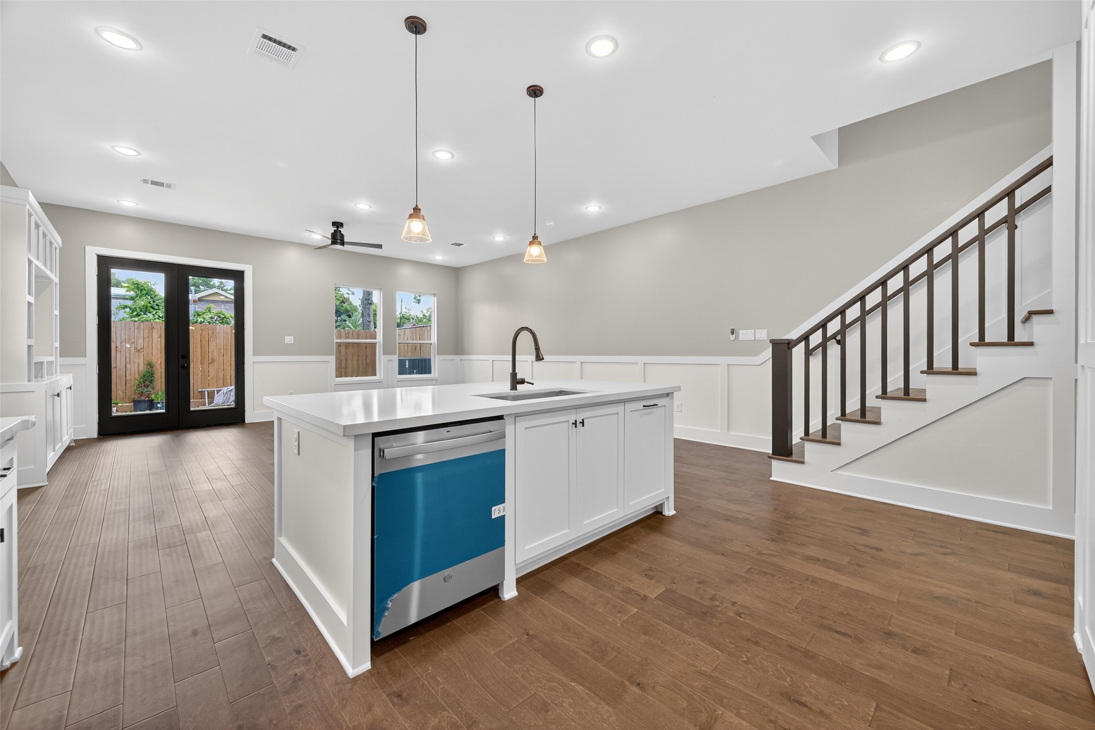 7325 Market Street Houston, TX 77020 - Photo 9 of 47 a large white kitchen with a large island oven a sink stainless steel appliances and cabinets