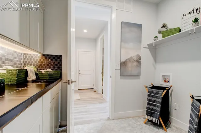a kitchen with stainless steel appliances kitchen island granite countertop a refrigerator and a sink