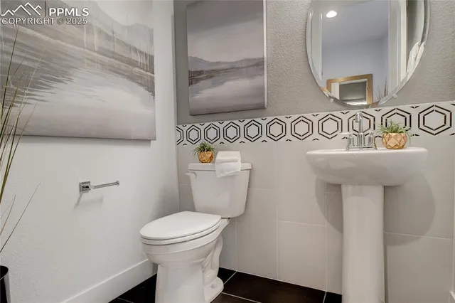 a bathroom with a toilet a sink and mirror