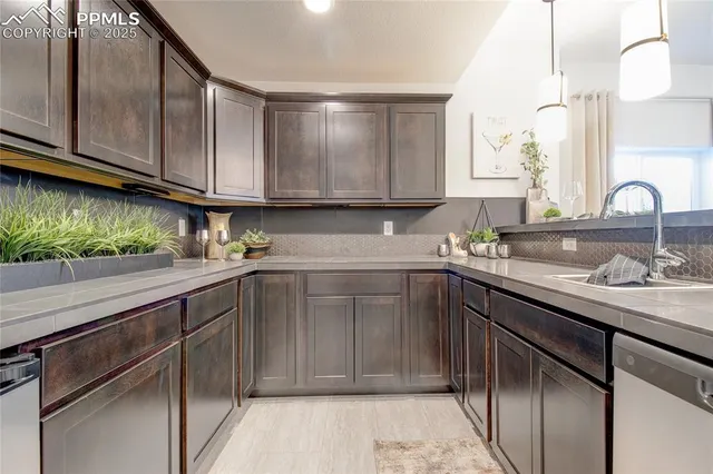 a kitchen with kitchen island granite countertop a sink stainless steel appliances and cabinets