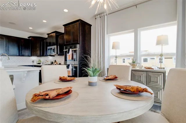 a kitchen with stainless steel appliances a sink a stove a refrigerator and cabinets